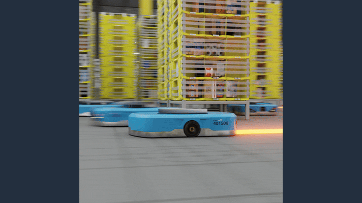 An Amazon warehouse robot navigating between shelving pods, its path coordinated by the DeepFleet AI model.